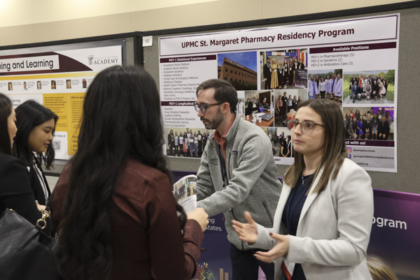 Residents and fellows networking at poster session